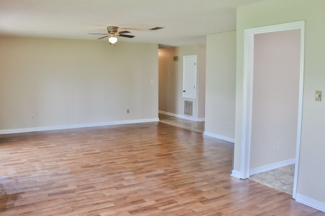 Second living area with ceiling fan and laminate flooring in Oakdale Louisiana home